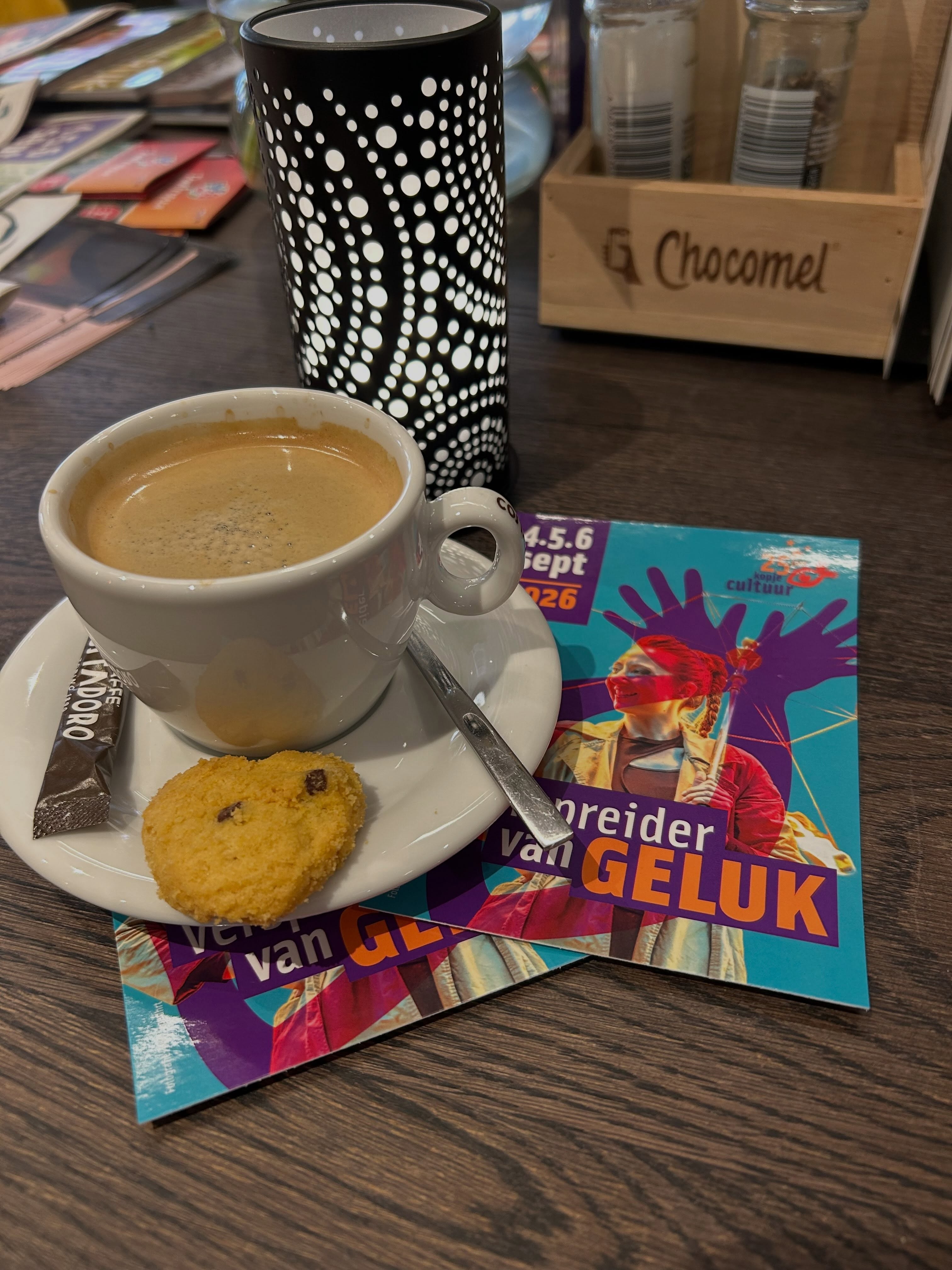 Koffie en een koekje aan tafel